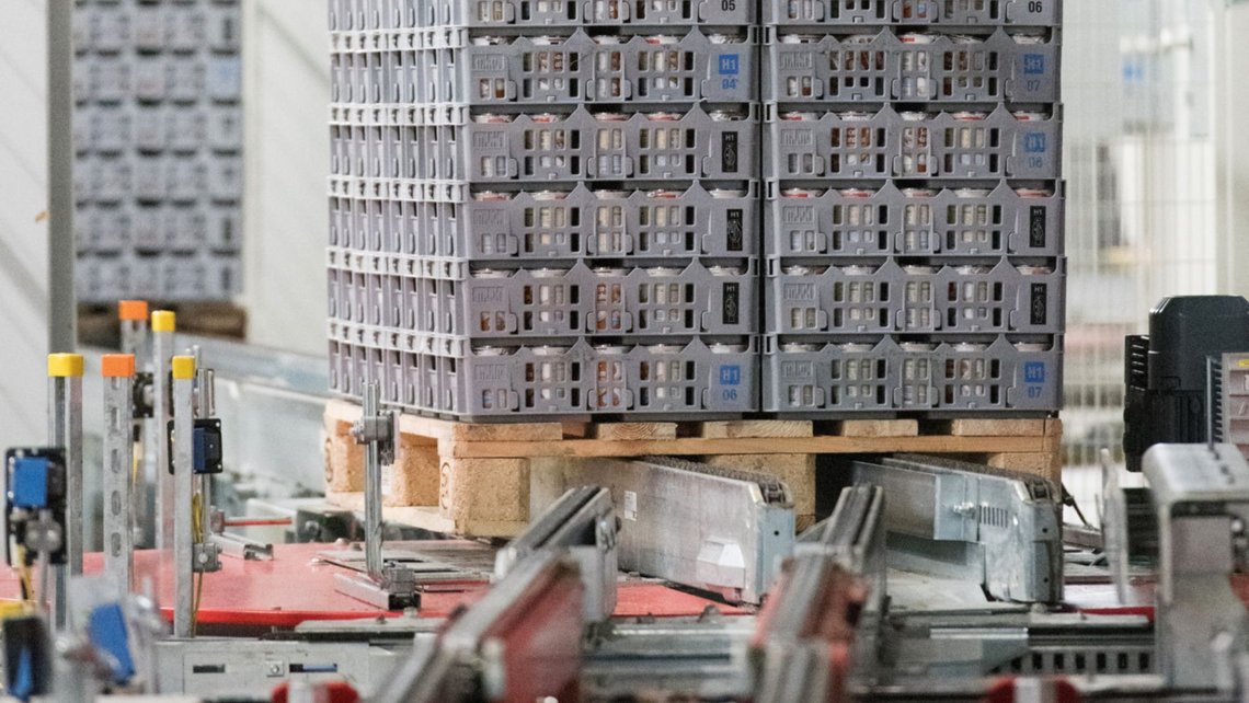large pallets of frozen goods on a conveyor belt in a warehouse