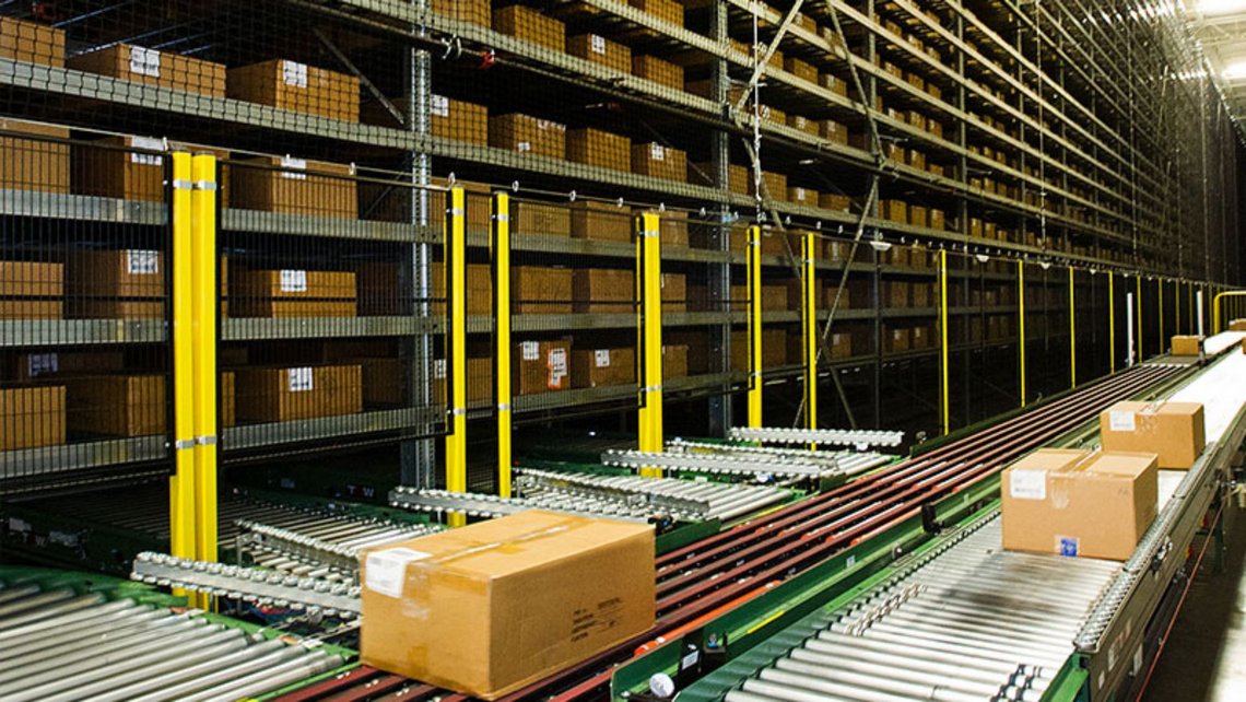 Cardboard boxes travelling on the conveyor belt inside of the GAP distribution center